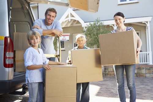 Local removals team handling furniture in an East London street