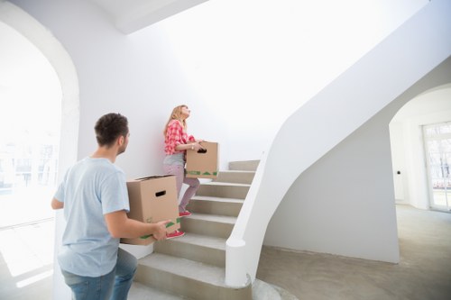 Packed moving boxes and furniture ready for transport in East London