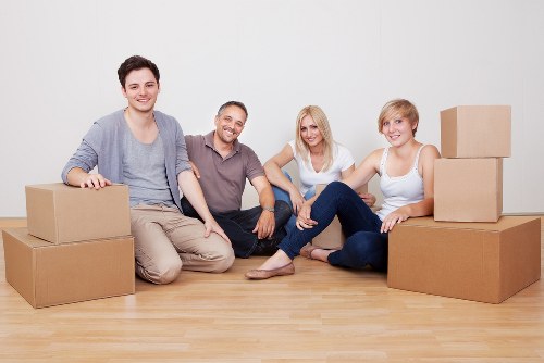 Trained movers handling furniture with safety awareness